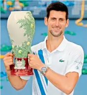  ?? AFP ?? Novak Djokovic of Serbia poses with the winner’s trophy after defeating Milos Raonic of Canada in the men’s singles final of the Western & Southern Open at the USTA Billie Jean King National Tennis Center in the Queens borough of New York City on Saturday. —