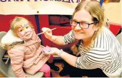  ??  ?? Brush strokes Sarah Morier, 3, gets her face painted by Lesley Watson