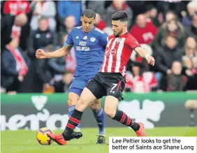  ??  ?? Lee Peltier looks to get the better of Saints ace Shane Long