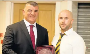  ??  ?? Scrum-half Jonathan Lock is awarded the 2nd XV Players’ Player of the Year award by Rowland Phillips