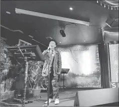  ??  ?? A man sings in a karaoke bar beside a portrait of King Jigme Khesar Namgyel Wangchuck in the capital city of Thimphu.