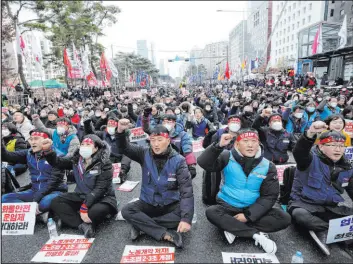  ?? Young-joon Ahn The Associated Press ?? Members of the Korean Confederat­ion of Trade Unions protest against the government’s labor policy Saturday near the National Assembly in Seoul, South Korea.