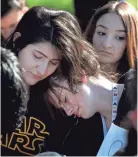  ?? MARK ZALESKI FOR THE TENNESSEAN ?? Yara Ali, left, and Zoe Newcomb of John Overton High School in Nashville join a class walkout Wednesday.
