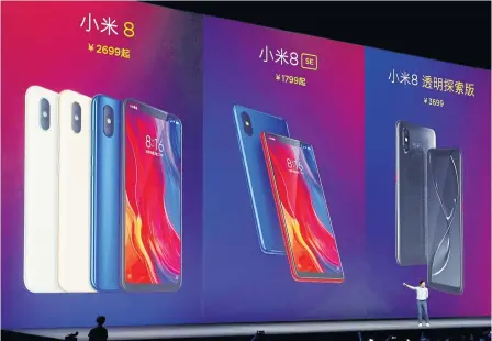  ?? REUTERS ?? Lei Jun, CEO of Xiaomi Inc, discloses price tags for the company’s new flagship Mi 8, an anniversar­y smartphone strikingly similar to Apple Inc’s iPhone X, during a product launch in Shenzhen yesterday.