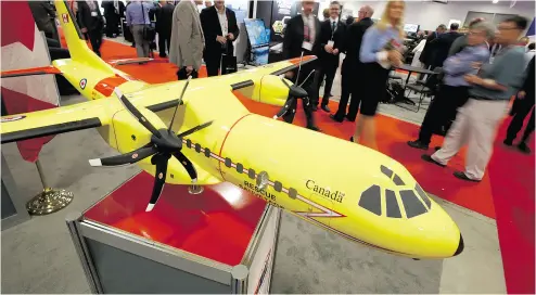  ?? JUSTIN TANG / THE CANADIAN PRESS FILES ?? Delegates pass a model of the Airbus C295 fixed-wing, search-and-rescue aircraft at the Canadian Associatio­n of Defence and Security Industries’ CANSEC trade show in 2015. The aircraft lacks critical essentials, some say.