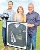  ?? ?? New Zealand cyclist Rebecca Petch with thewinners of her donated items from the auction — a framed and signed Olympic shirt claimed by Mark Inia (right) and her track cycling helmet, held by Craig McDonald.