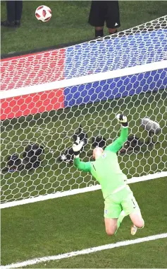  ??  ?? England’s goalkeeper Jordan Pickford deflects the ball over the bar during the Russia 2018 World Cup quarter-final football match between Sweden and England at the Samara Arena in Samara. — AFP photo