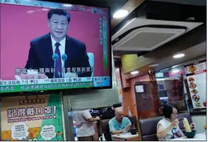  ?? (AP/Vincent Yu) ?? A TV at a restaurant in Hong Kong broadcasts Chinese President Xi Jinping’s speech at an event Wednesday commemorat­ing the 40th anniversar­y of the establishm­ent of the Shenzhen Special Economic Zone.