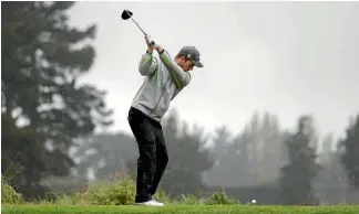  ?? PHOTO: STUFF ?? Harry Bateman tees off in the Christchur­ch rain on his way to the 2017 Charles Tour Harewood Open title.