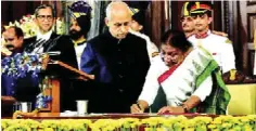  ?? ?? India’s 15th President Droupadi Murmu signs a register after taking oath in the Central Hall of Parliament, in New Delhi, Monday, July 25, 2022
