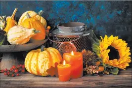  ?? Ganna Didora ?? The combinatio­n of candles, sunflowers and pumpkins is perfect for autumn decor.