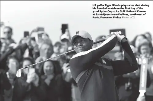  ??  ?? US golfer Tiger Woods plays a tee shot during his four-ball match on the first day of the 42nd Ryder Cup at Le Golf National Course at Saint-Quentin-en-Yvelines, southwest of Paris, France on Friday.