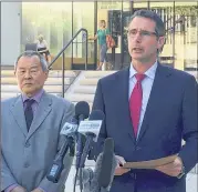  ?? CALEB JONES / ASSOCIATED PRESS ?? Paul Delacourt (right), head of the FBI bureau in Hawaii, speaks Monday outside the federal courthouse in Honolulu about the arrest of Sgt. Ikaika Kang. U.S. Attorney Elliot Enoki is at left.