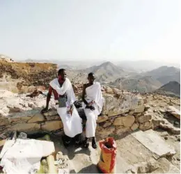  ??  ?? A pilgrim visits the Mount Al-noor, where Muslims believe Prophet Muhammad (PBUH) received the first words of the Holly Quran through Gabriel in the Hera cave, ahead of Hajj pilgrimage in the holy city of Makkah. Right: Pilgrims from Somalia rest while they climb Mount Al Noor on Saturday.