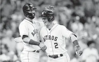 ?? Elizabeth Conley / Houston Chronicle ?? In what is becoming a familiar scene, Alex Bregman (2) is welcomed home by Marwin Gonzalez on Saturday after depositing a sixth-inning pitch into the Crawford Boxes for his 17th home run.