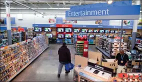  ?? AP FILE PHOTO ?? In this Dec. 15, 2010 file photo, a view of the entertainm­ent section of a Walmart store is seen in Alexandria, Va. Walmart is taking down all signs and displays from its stores that depict violence, following a mass shooting at its El Paso, Texas location that left 22 people dead. The retailer, according to an internal memo, instructed employees to turn off or unplug any video game consoles that show violent games, as well as ensure that no movies depicting violence are playing in its electronic­s department­s.