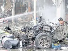  ?? REUTERS ?? ABOVE Remains of destroyed cars are seen at the blast site outside a Big C Supercentr­e in Pattani.