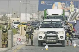  ?? Majdi Mohammed Associated Press ?? ISRAELI soldiers search a Palestinia­n vehicle on Tuesday, a day after a deadly shooting on a highway near the Dead Sea and the West Bank city of Jericho.