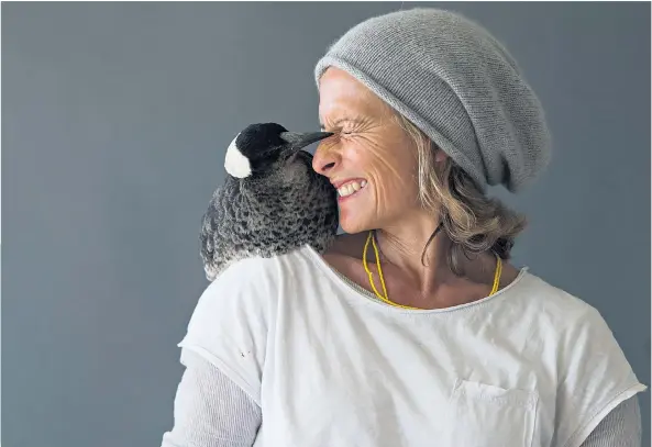  ??  ?? Winged messenger: Sam Bloom with Penguin, the magpie that became her constant companion