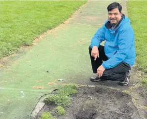  ??  ?? ●●Coun Faisal Rana inspects the pitch