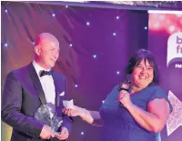  ??  ?? Robert George receives the Good Neighbour Award from presenter Louise Apsee