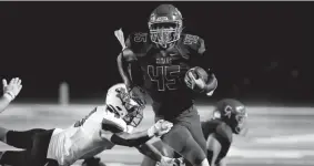  ?? SARAH PHIPPS/THE OKLAHOMAN ?? Carl Albert’s Kentrell Bizzell gets by McGuinness’ Adam Wheeler during a game on Oct. 9 in Midwest City.