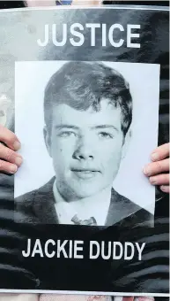  ?? PAUL FAITH / AFP / GETTY IMAGES ?? A relative holds a portrait Thursday of Jackie Duddy, one of the 13 killed on Bloody Sunday in Derry (Londonderr­y) following the announceme­nt that a former British soldier will be charged with murder over the 1972 killings.