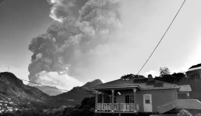  ?? AP PHOTOS ?? In this April 13, 2021 file photo, ash rises from the La Soufriere volcano as it erupts on the eastern Caribbean island of St Vincent. The eruptions displaced nearly 20% of the population.