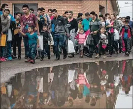  ?? Loren Elliott For The Times ?? NEWLY RELEASED migrants arrive at a Catholic Charities center in McAllen, Texas. Immigrant advocates suggested the release could be a political stunt.