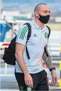  ??  ?? JETTING OFF: Celtic manager Neil Lennon and captain Scott Brown leaving Glasgow Airport for Dubai.