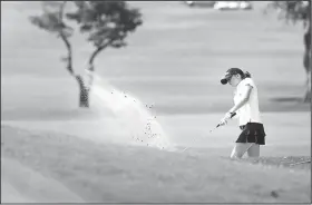  ?? NWA Democrat Gazette/SPENCER TIREY ?? Greenwood’s Ella Austin chips out of the sand on hole No. 1 Thursday at the Springdale Country Club.