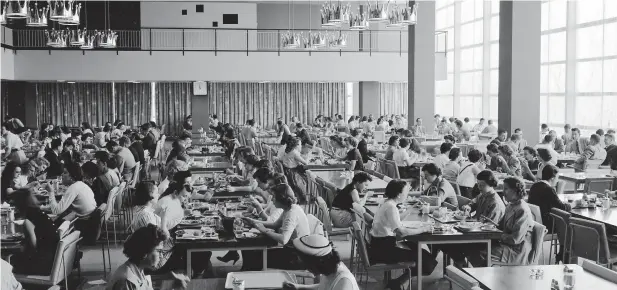  ?? ?? A photo provided by Hallmark shows employees dining in the corporate cafeteria at company headquarte­rs in Kansas City, Missouri, in 1956. Hallmark helped set the template for the huge corporate cafeteria with its Crown Room, which opened in 1956. (Hallmark via The New York Times)