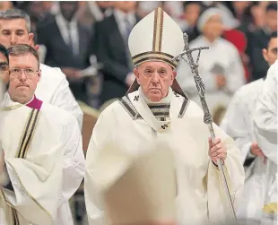  ?? Picture: AP. ?? Pope Francis leaves after celebratin­g Christmas Eve Mass in St Peter’s Basilica at the Vatican.