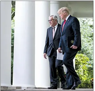  ?? The New York Times/DOUG MILLS ?? European Commission President Jean-Claude Juncker and President Donald Trump walk to the White House Rose Garden for a news conference Wednesday. “We had a big day, very big,” Trump said.