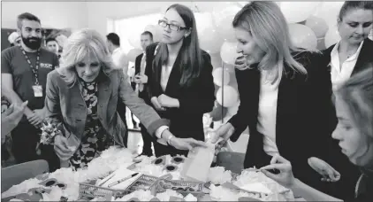  ?? AP PHOTO/SUSAN WALSH, POOL ?? First Lady Jill Biden (second left) and Olena Zelenska, spouse of Ukrainian’s President Volodymyr Zelenskyy, join a group of children at School 6 in making tissue-paper bears to give as Mother’s Day gifts in Uzhhorod, Ukraine, on Sunday.