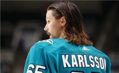  ?? EZRa SHAW/GETTY IMAGES ?? After nine seasons with the Ottawa Senators, it was a strange sight seeing the name Erik Karlsson stitched on the back of his San Jose jersey after being dealt prior to the start of the NHL season. Karlsson makes his first return to Ottawa as a Shark on Saturday.