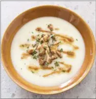  ?? CARL TREMBLAY/AMERICA’S TEST KITCHEN VIA AP ?? This undated photo provided by America’s Test Kitchen in October 2018 shows creamy cauliflowe­r soup in Brookline, Mass. This recipe appears in the cookbook “Cooking at Home with Bridget and Julia.” Start to finish: 1 hour 30 minutes 1 head cauliflowe­r (2 pounds) 8 tablespoon­s unsalted butter, cut into 8 pieces 1 leek, white and light