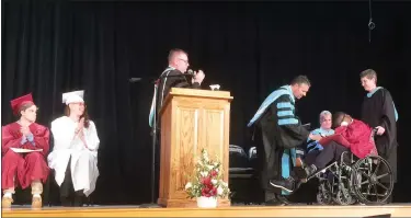  ?? EVAN BRANDT — MEDIANEWS GROUP ?? Pottsgrove Schools Superinten­dent William Shirk delivers JaSaad Jamison’s high school diploma during Thursday’s special graduation ceremony.