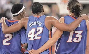  ?? ?? Florida’s Al Horford (42) puts his arms around teammates Corey Brewer (2) and Joakim Noah (13) as they celebrate in the final seconds of the game before defeating the UCLA Bruins 73-57 during the NCAA National Championsh­ip game at the RCA Dome in Indianapol­is on April 3, 2006.