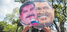  ?? FOTO: DPA ?? Pappfigure­n von Venezuelas Präsident Nicolas Maduro ( links) und seinem Vorgänger Hugo Chavez.