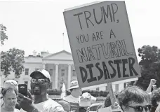  ?? NICHOLAS KAMM, AFP/GETTY IMAGES ?? Climate change protesters outside the White House in April.