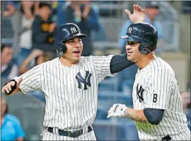  ?? KATHY WILLENS/AP PHOTO ?? Jacoby Ellsbury of the Yankees, left, celebrates with Gary Sanchez after scoring on Sanchez’s two-run homer in the first inning of Tuesday’s game at New York.