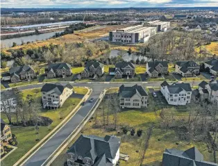  ?? JAHI CHIKWENDIU/THE WASHINGTON POST ?? Microsoft and Amazon data centers on former farmland near a residentia­l area in Northern Virginia. AI and cryptocurr­ency mining are putting new pressures on the nation’s energy grid.