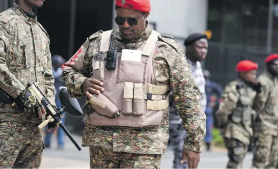  ?? Picture: Refilwe Modise ?? HEAVIES. Armed Economic Freedom Fighters members are pictured outside the venue of the Commission of Inquiry into State Capture in Parktown, Johannesbu­rg, earlier this week.