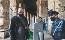  ?? DOMENICO STINELLIS / AP ?? A visitor has his temperatur­e checked as he arrives at the Colosseum in Rome on April 27. The ancient Roman gladiator arena reopened after being closed for 41 days due to COVID-19.