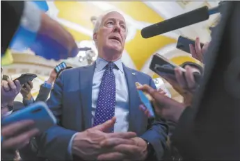  ?? AP file photo ?? Sen. John Cornyn,
R-Texas, is surrounded by reporters as he heads to the chamber at the Capitol in Washington on Feb. 7. Cornyn has informed his colleagues that he intends to run for Senate Republican leader. He’s the first senator to announce a campaign after Sen. Mitch McConnell said on Wednesday that he’ll step down from the post in November.