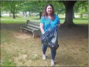  ?? BILL RETTEW JR. – DIGITAL FIRST MEDIA ?? Henderson High School Assistant Principal Elisha Ozer smiles as she picks up litter in Marshall Square Park while plogging.