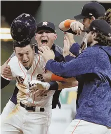  ?? AP PHOTO ?? AFTER-HOURS PARTY: Alex Bregman (left) gets mobbed by Astros teammates after his RBI single beat the Dodgers in 10 innings, 13-12, in a Game 5 of the World Series that didn’t end until 1:39 yesterday morning.