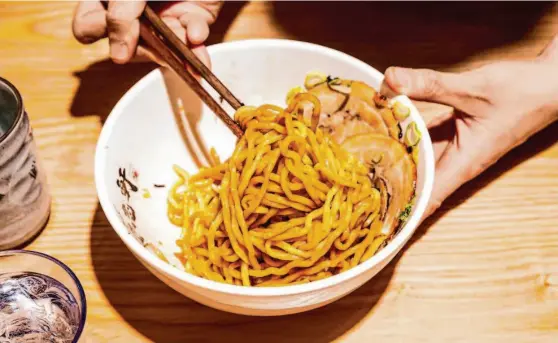  ?? Photos by Stephen Lam/The Chronicle ?? Kajiken, a popular Japanese chain that specialize­s in brothless ramen, or abura soba, is opening its first California location in San Mateo.