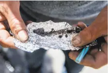  ?? Jessica Christian / The Chronicle ?? Roger Boyd holds a piece of foil with fentanyl in the Tenderloin. Fatalities from the drug are rising in San Francisco.